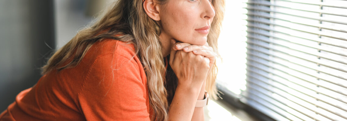 Adult woman looking out a window