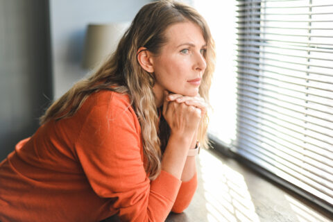 Adult woman looking out a window