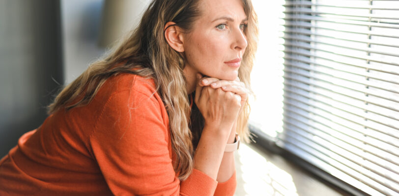 Adult woman looking out a window